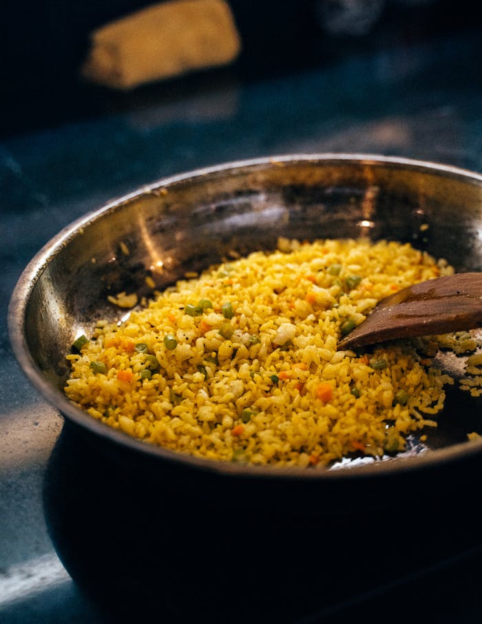 Close-up of delicious fried rice with vegetables in a pan, perfect for culinary usage.